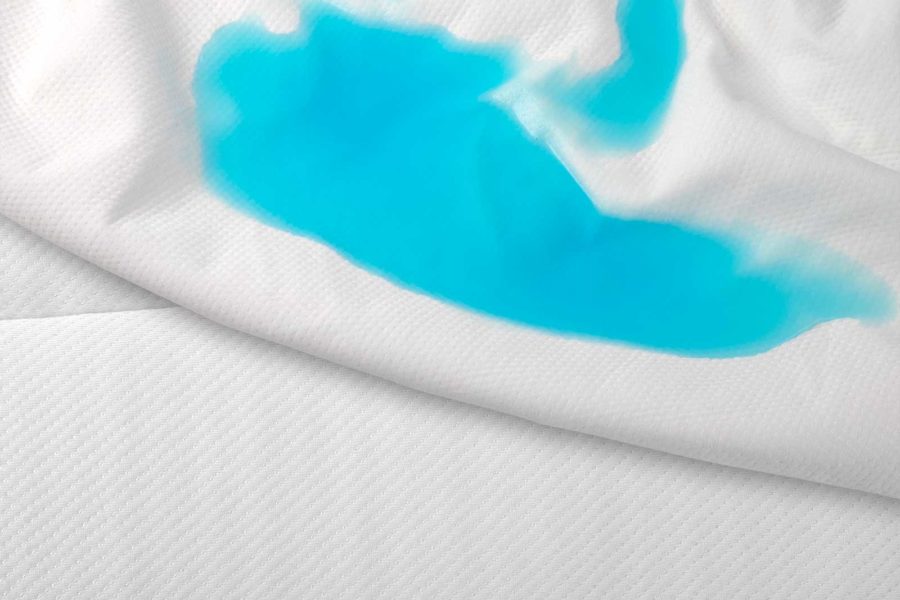 Mattress protector absorbing blue liquid while Brunswick mattress stays clean.