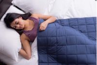 Woman sleeping peacefully with Classic Weighted Blanket draped over her body